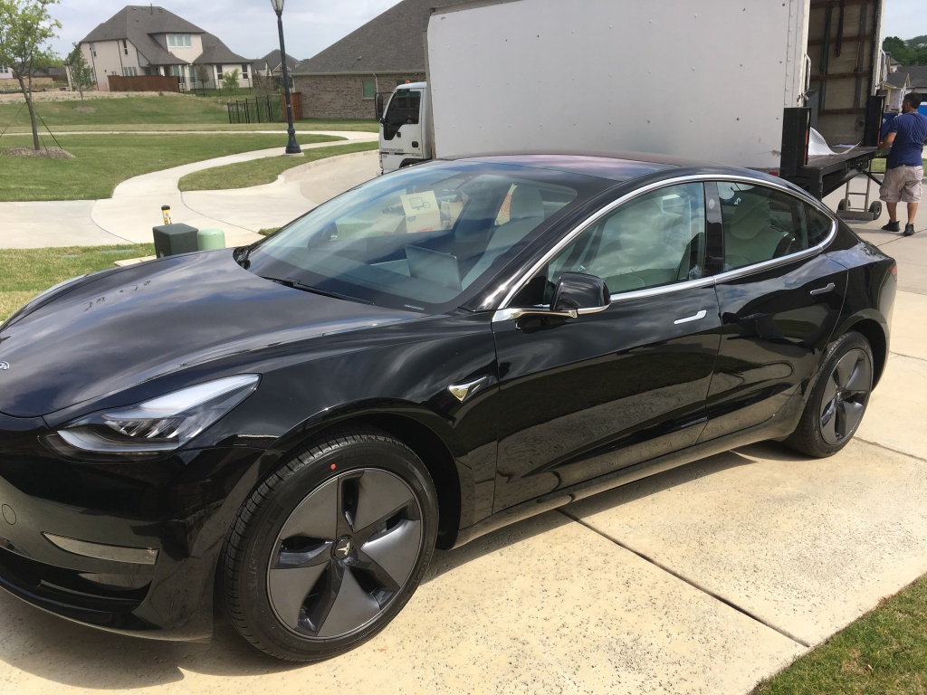 Black Tesla Model 3 in our driveway
